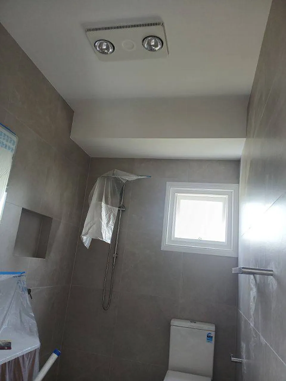 Bathroom with painted ceiling and window frame, fittings going in